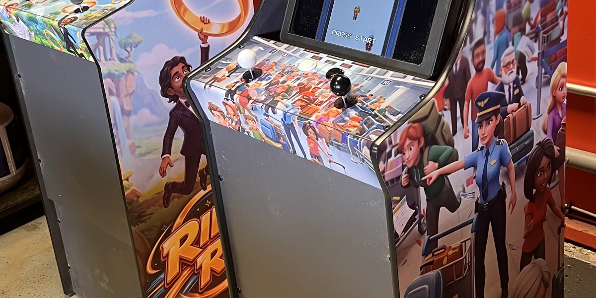Two finished wedding arcade cabinets with custom side art and printed control panels