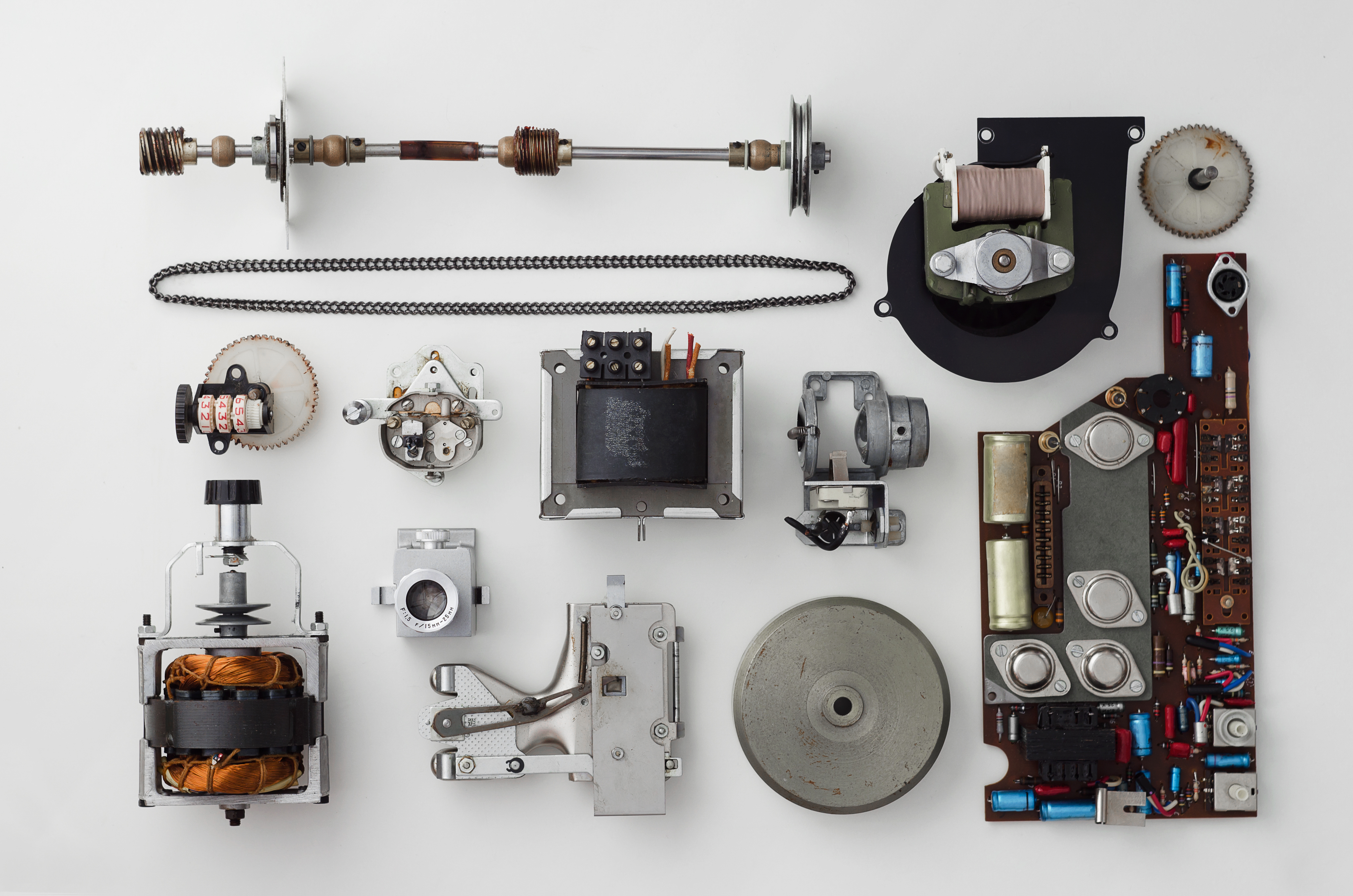 Parts of a vintage device laid out on a workbench — similar to the process of rebuilding a vintage phone for the Hear Hear Modern