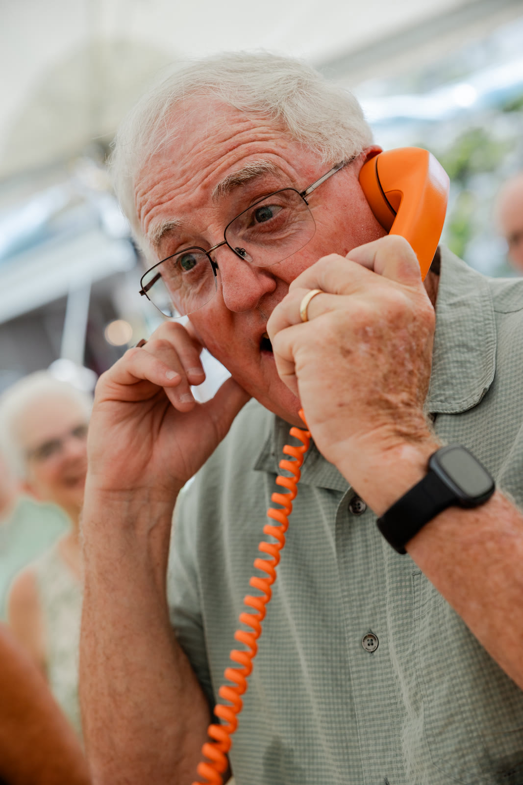 Older wedding guest leaving a voice message on a Hear Hear guestbook phone