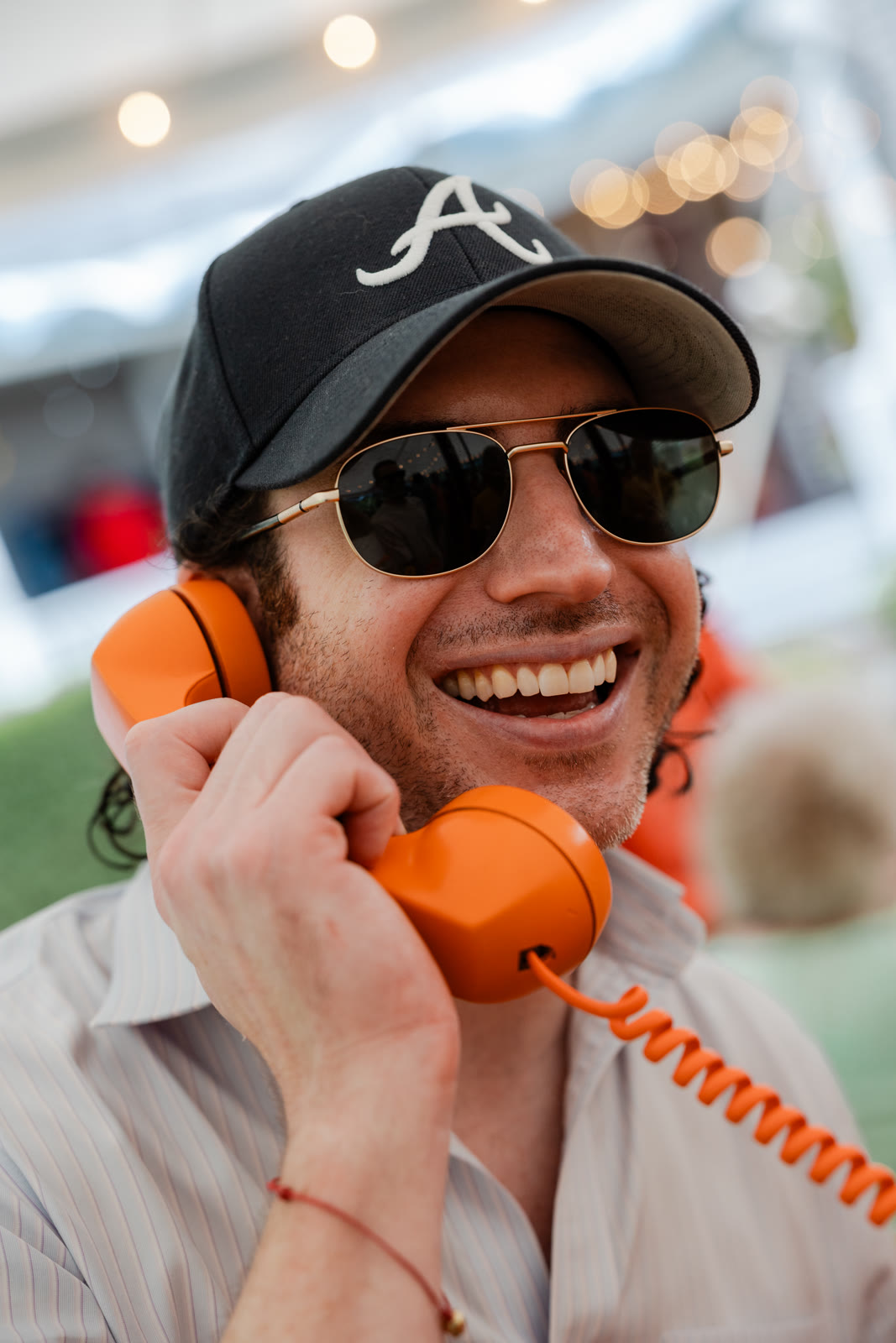 Wedding guest laughing while leaving a message on the Hear Hear Modern phone